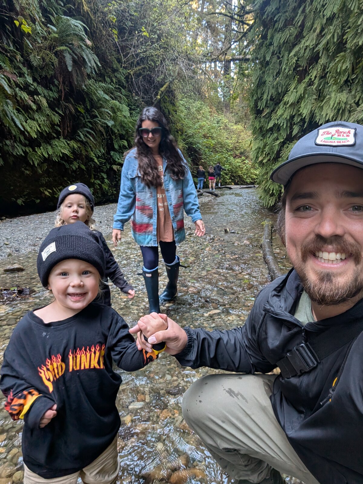 Dillon Jones hiking through a creek with his family